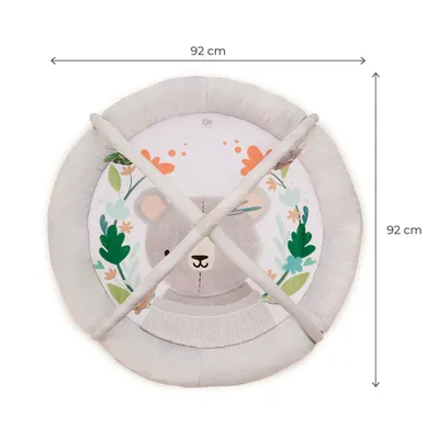 A top-down view of a round play mat with a bear design and hanging toys.