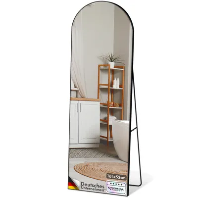 A full-length mirror reflecting a bathroom scene with a bathtub, shelves, and cabinets.