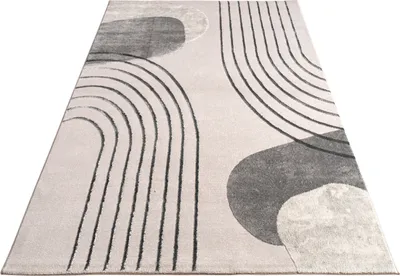 A close-up, angled view of a rug with a geometric pattern.