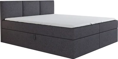 A dark gray boxspring bed with a white mattress and a headboard.