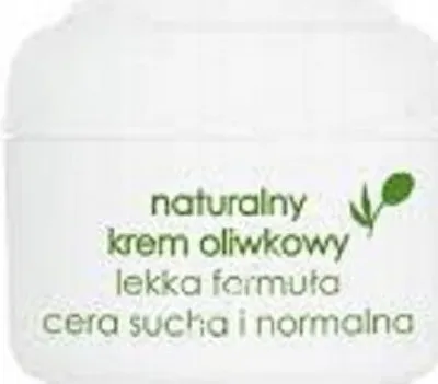 A white jar of cream with green text and an olive illustration.