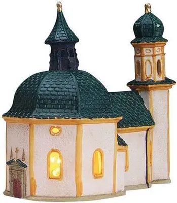 A miniature church building, likely a decorative item or part of a Christmas village display.