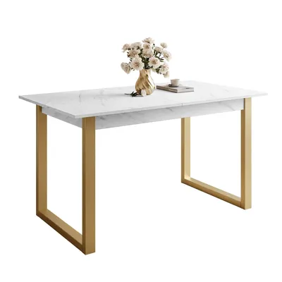 A white marble dining table with gold legs, featuring a vase of flowers and a book on top.