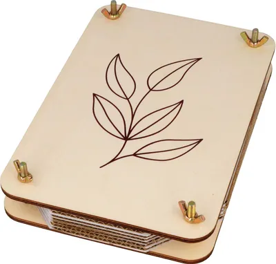 A wooden herbarium press with a leaf design on the top.