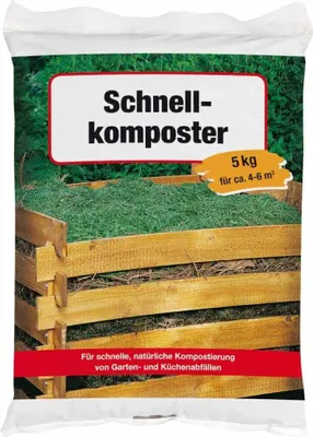 A bag of compost with a wooden compost bin in the background.