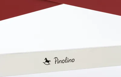 A close-up view of a white surface with a red border at the top and a logo with text on the white surface.