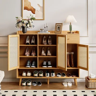 A wooden shoe cabinet with multiple shelves and doors, displaying various shoes and boots.