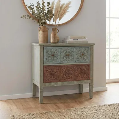 A vintage-style wooden dresser with two drawers is placed in a room with a round mirror above it.