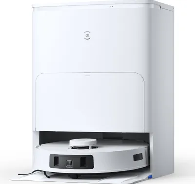 A white robot vacuum cleaner docked in its charging and emptying station, presented against a white background.