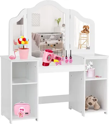 A white children's vanity table with a tri-fold mirror, featuring toy makeup and accessories, set against a neutral background.