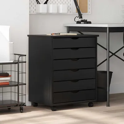 A black filing cabinet with six drawers is shown in a room with a desk and a shelving unit.