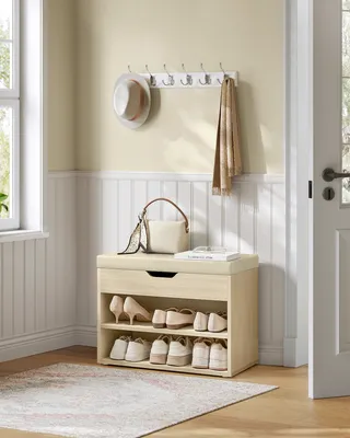 A entryway with a shoe cabinet, hat, and handbag.