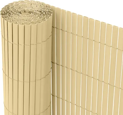 A rolled-up privacy screen made of beige plastic slats.