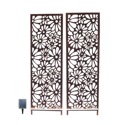 Two decorative garden screens with a floral pattern and a solar light.