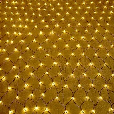 A close-up, overhead view of a net of warm white LED lights spread out on a yellow surface.