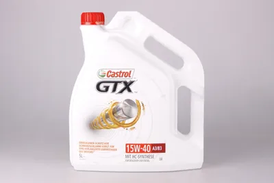 A white plastic jug of Castrol GTX 15W-40 A3/B3 engine oil is shown against a plain background.