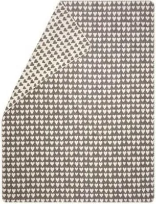 A folded blanket with a heart pattern.