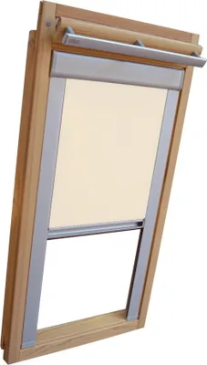 A wooden framed skylight window with a cream colored blackout blind partially rolled down.
