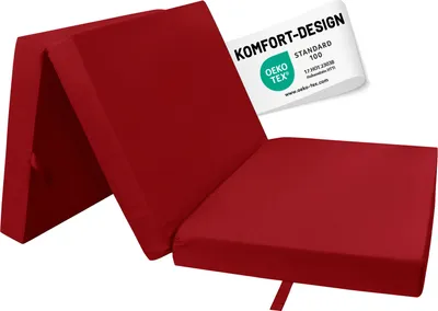 A red foldable mattress is shown in an unfolded state, with a label indicating its quality certification.