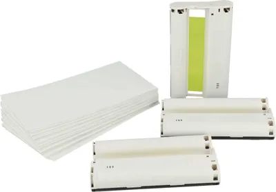 A stack of white paper and several white ink cartridges are arranged on a white background.