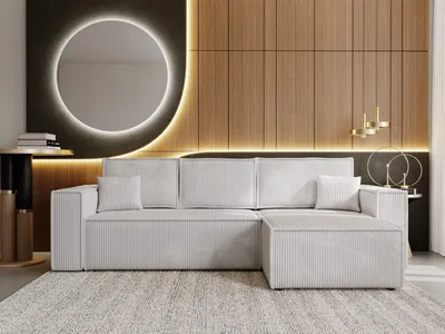 A modern living room with a light gray sectional sofa, a round mirror with backlighting, and wood-paneled walls.
