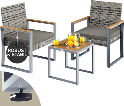 A set of outdoor furniture including two chairs and a small table, with drinks and fruit on the table.