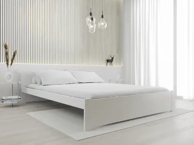 A white bed with white bedding is shown in a minimalist bedroom setting.