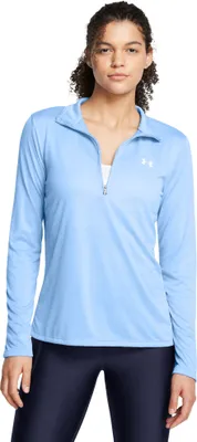 A woman is modeling a light blue long-sleeved shirt with a quarter-zip closure.