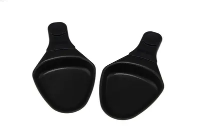 Two black raclette pans on a white background.