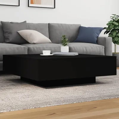 A modern living room with a gray sofa and a black coffee table.