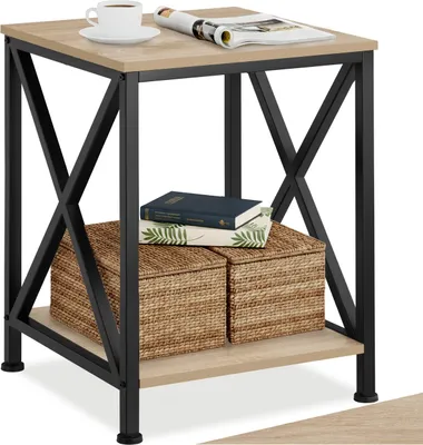A close-up shot of a wooden and black side table with items on it.