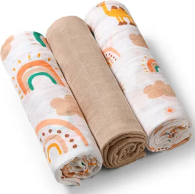 Three rolled up baby blankets with different patterns.