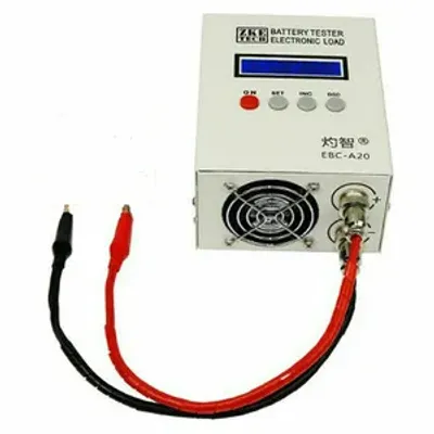 A white electronic battery tester with a blue display screen and various buttons, connected to red and black alligator clip wires.