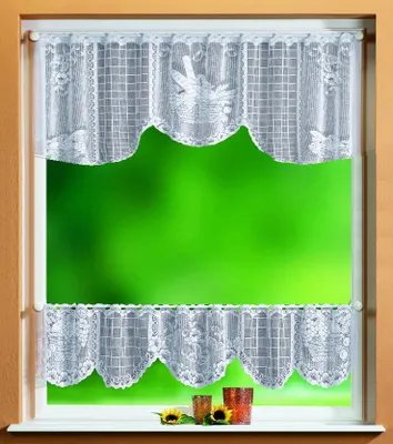 A window with lace curtains and a green background visible through the window.