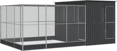 A large, dark gray metal aviary with a mesh enclosure attached to a solid shed-like structure.