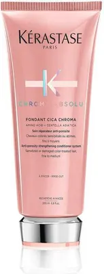 A product shot of a pink conditioner bottle with a silver cap.