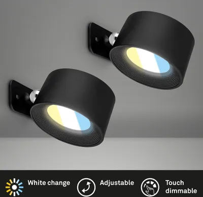 Two black wall lights are mounted on a gray ceiling. The lights have adjustable heads and emit a warm and cool white light. Below the lights, there are icons and text describing features like 'White change', 'Adjustable', and 'Touch dimmable'.