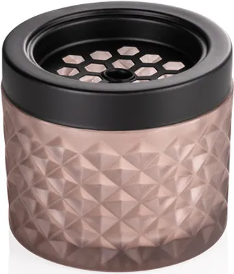A rose gold ashtray with a black lid and a honeycomb pattern on the lid.