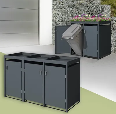 Two sets of dark gray metal trash can enclosures are shown. The foreground shows a three-unit enclosure with open tops and closed doors. The background shows a single-unit enclosure with a planter on top, one door open revealing a trash bin, and another do