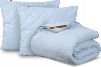 A set of light blue bedding, including two pillows and a folded comforter, is displayed against a white background.