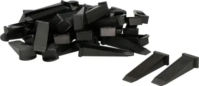 A pile of black plastic tile leveling wedges.