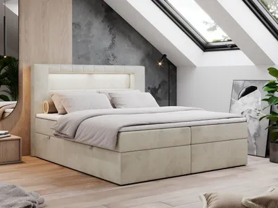 A bedroom with a boxspring bed, skylights, and modern decor.