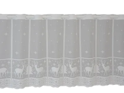 A white lace curtain with a deer and snowflake pattern.