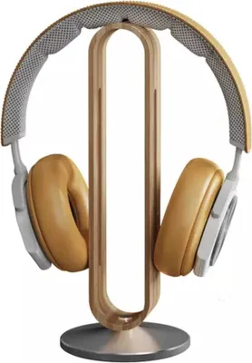 A pair of headphones rests on a wooden stand.