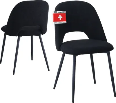 Two black chairs are shown against a white background. One chair is in the foreground, and the other is slightly behind and to the left.