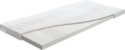 A white mattress topper is shown on a white background, with a section cut away to reveal its internal layers.