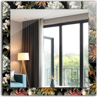 A decorative mirror with a floral and bird motif, reflecting a room interior with a window and curtains.