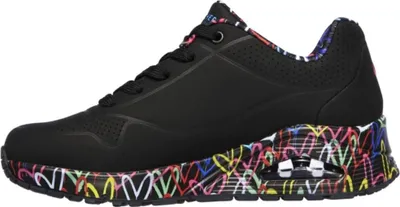 Side view of a black Skechers sneaker with a colorful heart pattern on the sole.