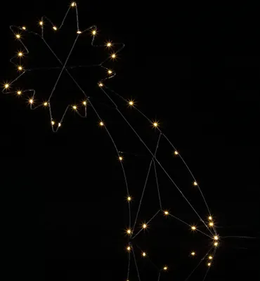 A close-up shot of a lit-up star decoration against a black background.
