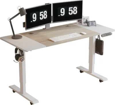 A standing desk with two monitors, a keyboard, a mouse, a lamp, and headphones.